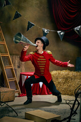 Illusionist or showman. Cinematic portrait of emotive man retro circus entertainer announces start...