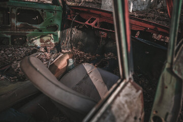 Destroyed abandoned Soviet car in the exclusion zone, Pripyat region, Chernobyl disaster, Ukraine