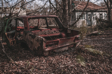 Destroyed abandoned Soviet car in the exclusion zone, Pripyat region, Chernobyl disaster, Ukraine