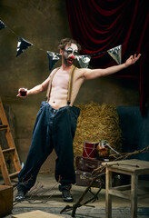 Jester. Sad male clown with stage makeup going through a personal tragedy, despair in the old retro...