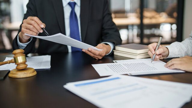 Lawyer With Lawsuit Meeting With Client Discussing With Contract Agreement At Courtroom..