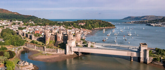 Aerial view with Conwy town and the medieval castle, the famous landmark of Wales and UK, captured...