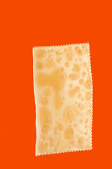stuffed fried pastry closed on isolated orange background