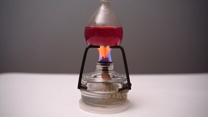 Close-up boiling liquid in a flask in the laboratory. Heated flask