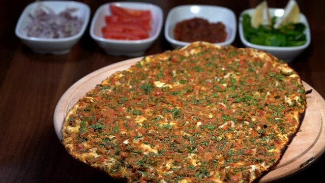 Making of Traditional Turkish meal lahmacun and pide on barbeque.