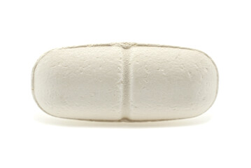 Medical tablet on a white background close-up. Vitamins isolate