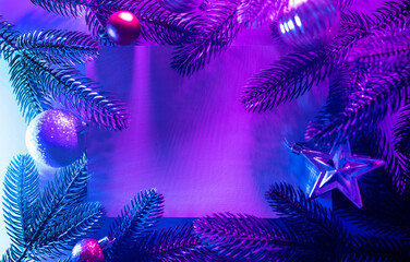 Christmas layout with christmas tree branches, christmas decorations in vibrant neon glow. copy...