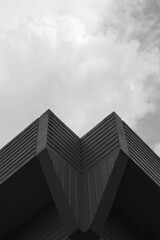 black and white building with clouds