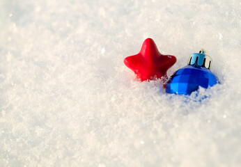 Christmas decor ball and star on natural white snow background, copy space