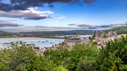 Fototapeta na wymiar Conwy town and The Castle, the awesome landmark medieval fortress in Wales, UK captured at sunset