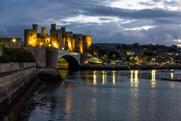 Fototapeta premium Conwy town and The Castle, the awesome landmark medieval fortress in Wales, UK captured at sunset