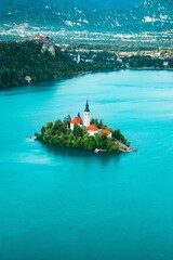 Vertical aerial of the beautiful island on Bled turquoise lake in Slovenia, great for backgrounds