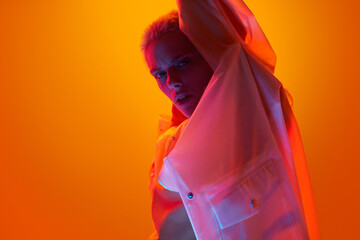 Androgynous female model under bright neon light
