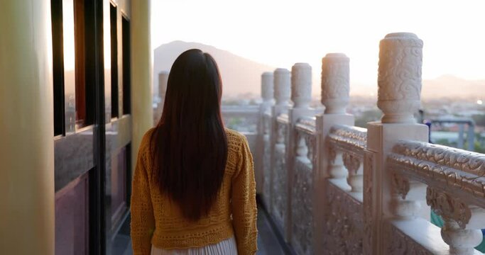 Woman go BaoHu Dimu Temple at Puli of Nantou of Taiwan in the evening