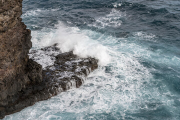 ocean waves dashing on volcanic cliffs at Fortim do Faial, Madeira