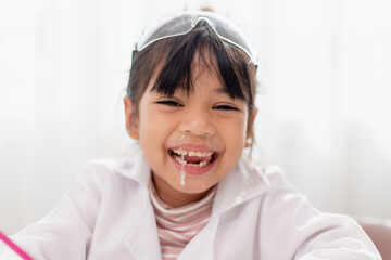 little Asian girl. child has a runny nose with clear snot,virus