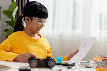 Asia students learn at home in coding robot cars and electronic board cables in STEM, STEAM, mathematics engineering science technology computer code in robotics for kids concept.