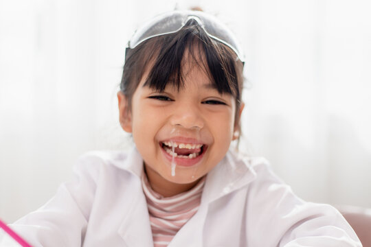 little Asian girl. child has a runny nose with clear snot,virus