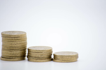 Coins of different monetary value on an unfocused background isolated on white with copy space. inflaction