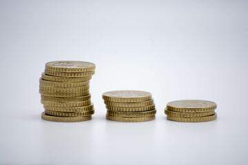 Coins of different monetary value on an unfocused background isolated on white with copy space. inflaction