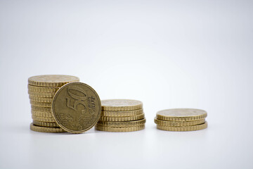 Coins of different monetary value on an unfocused background isolated on white with copy space....