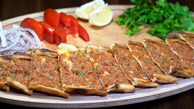 Making of Traditional Turkish meal lahmacun and pide on barbeque.