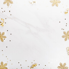 Christmas decorations in gold colors on white background. Gift, holiday and celebration concept, top view