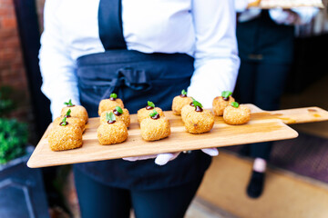 Wedding reception event party catering with appetisers and canapés being served by servers in the...