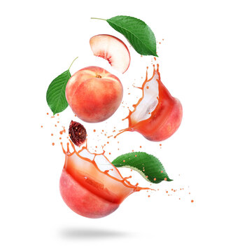 Whole and sliced peaches with juice splashes in the air isolated on a white background