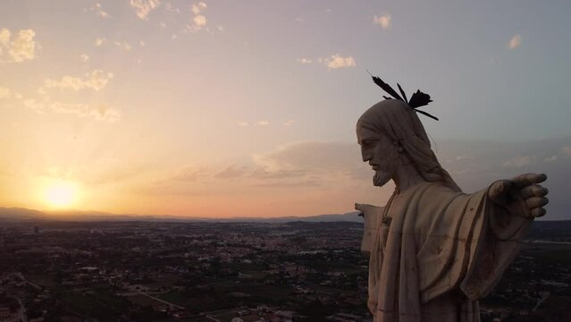 Statue of Jesus Christ short shot.Cristo de Monteagudo, Murcia, Spain. aerial video at sunset