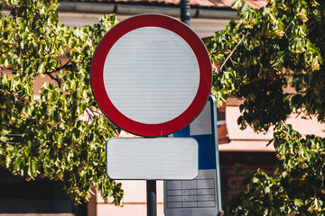 Traffic prohibited road sign made of a red ring or circle with white and an empty white board...