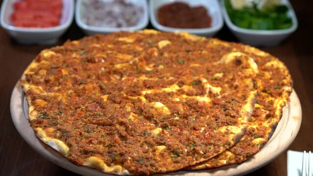 Making of Traditional Turkish meal lahmacun and pide on barbeque.