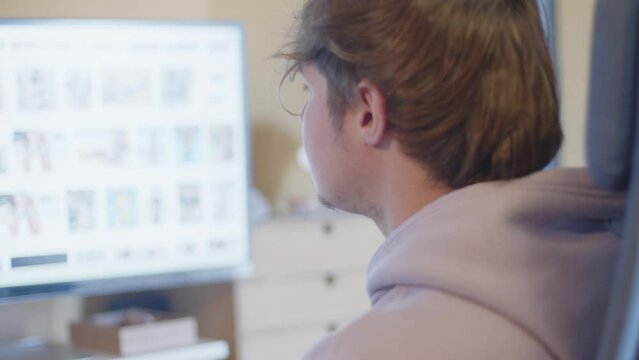 Young mand watching naked women in the computer screen	