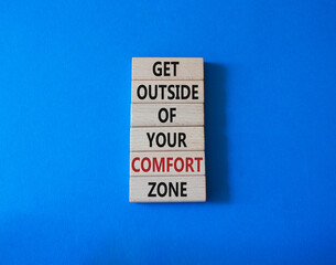 Get outside of your comfort zone symbol. Concept words Get outside of your comfort zone on wooden blocks. Beautiful blue background. Business and Get outside of your comfort zone concept. Copy space.