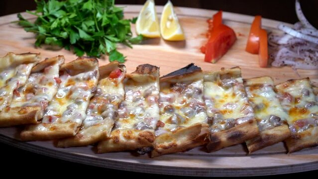Making of Traditional Turkish meal lahmacun and pide on barbeque.