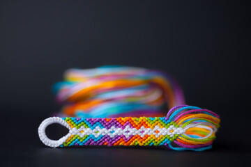 Friendship bracelet in the process of being made - with a beautiful blurry background