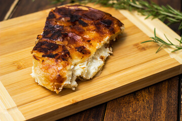 Homemade cheese pie, one piece on cutting board