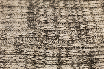 Close up on a cozy and warm fabric of a beige winter sweater