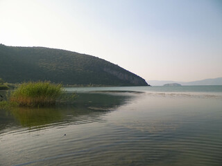 Fototapeta na wymiar Coast of Lake Prespa and Mountains of Galicica National Park.