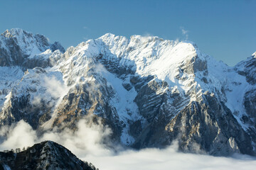 Julian Alps Slovenia, peak Debela Pec 2014 m, winter hiking in Triglav with snowy peaks and mist 
