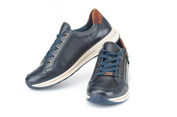 Pair of modern black sport sneakers close up isolated on white background