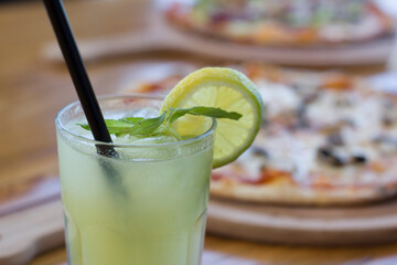 glass of lemonade and pizza 