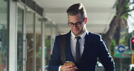 Phone, walking and businessman in a city networking via email or social media after a successful deal. Internet, goals, happy worker on downtown street typing. chat or texting on social network site