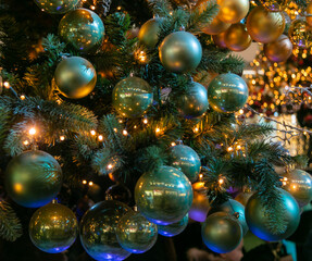 Many different Christmas balls on the Christmas tree. Festive Christmas toys. Christmas decorations. Close-up.