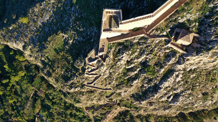 Aerial drone photo of iconic fortress of Palamidi built uphill overlooking old city of Nafplio well...
