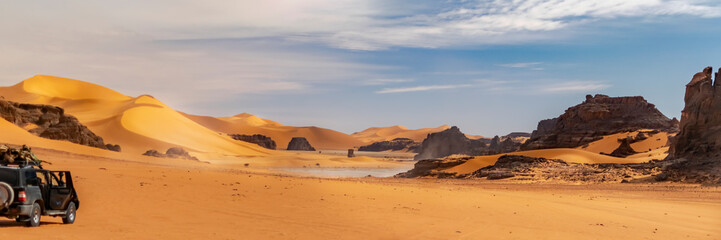 Panoramic view of Sahara Desert sand dune and rocky mountain off road nature.Tadrart Rouge, Djanet,...