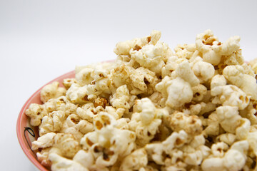Popcorn on a plate on a white background