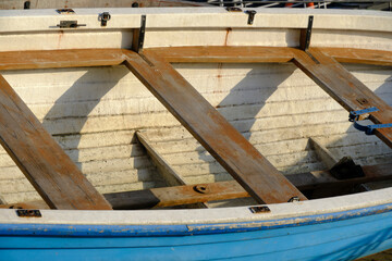 Old wooden boat lying shore.