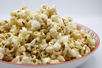 Popcorn on a plate on a white background