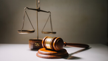 Business and lawyers discussing contract papers with brass scale on desk in office. Law, legal services, advice, justice and law concept